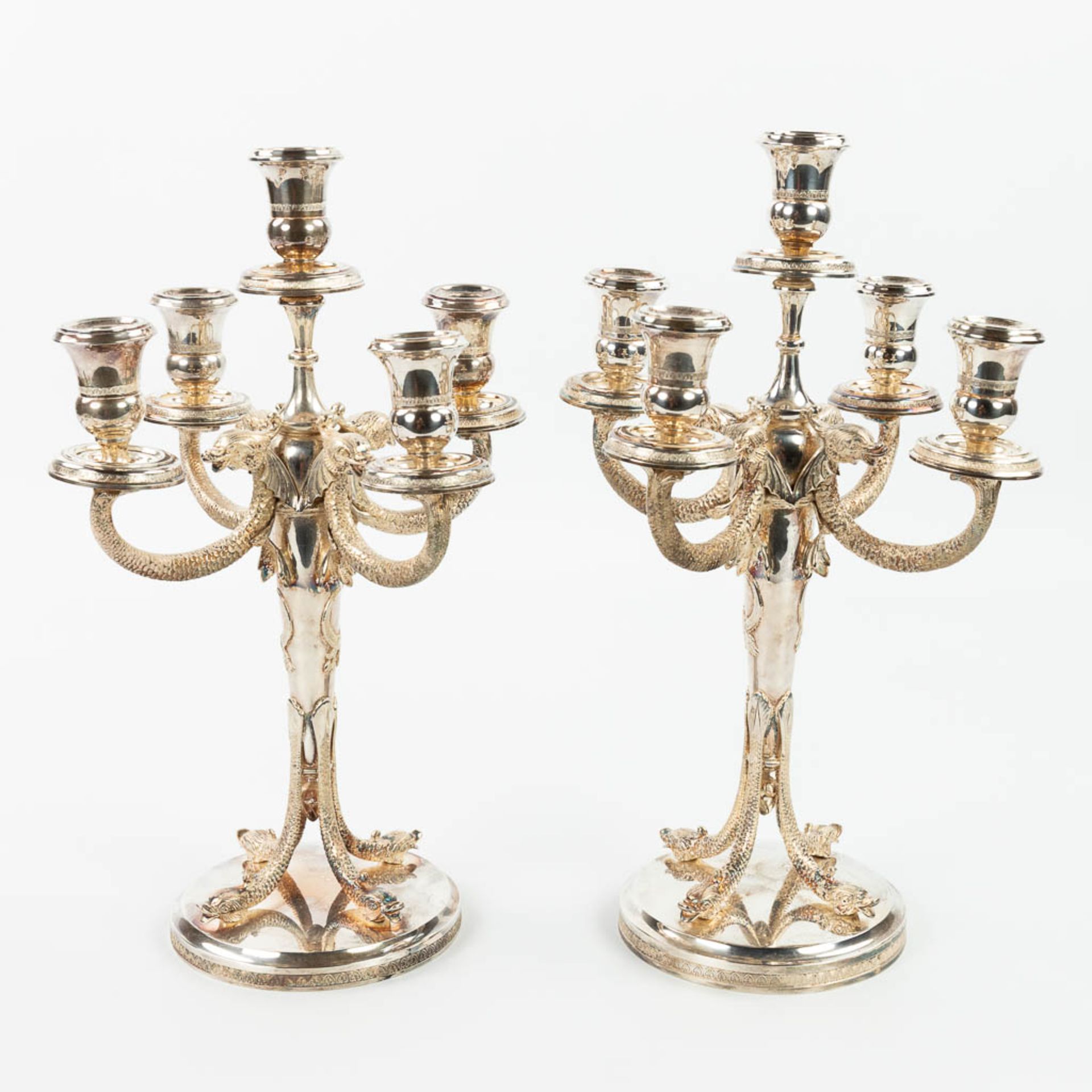 A pair of silver candelabra, decorated with mythological figurines. (H:41cm)