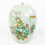 A Chinese jar with lid and decorated with children looking in the fishbowl. (H:31cm)