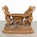 A large terracotta statue of two children and a basket, made of terracotta and marked 'Goldscheider