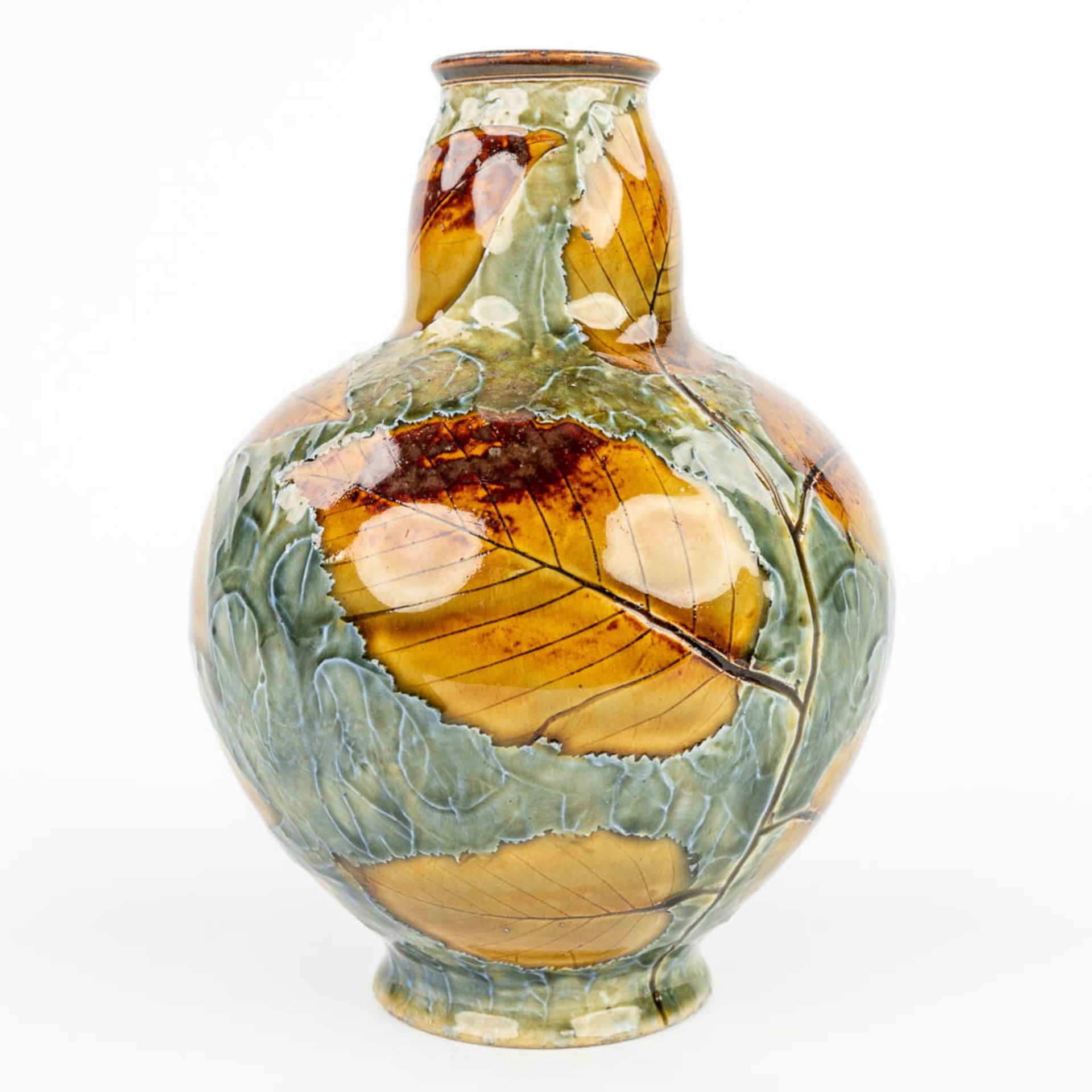 A vase decorated with leaves and made of stoneware marked Royal Doulton. (H:18cm)