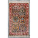 An Oriental hand-made carpet made in Kashmir. (122 x 77 cm)