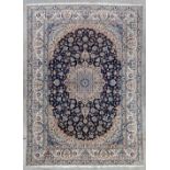 An Oriental hand-made carpet, wool and silk, Nain (338 x 248 cm)