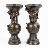 A pair of bronze Japanese bronze vases with a flower and dragon decor. (61 x 27 cm)
