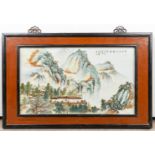 A Chinese porcelain plaque, decorated with a mountain landscape and temple. (55 x 32 cm)