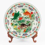 A Chinese plate with a decor of fish and marked Kangxi. (45cm)