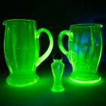 A collection of Uranium Glass, two pitchers and a salt dispenser. (20,5cm)
