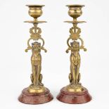 A pair of candlesticks with lion figurines mounted on a red marble base. (21 x 8cm)