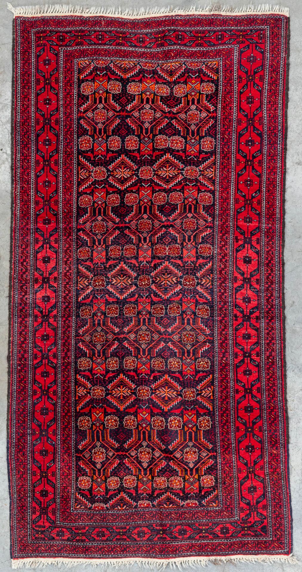 An hand-made carpet and marked Belutek, Iran.Ê(101 x 201 cm)