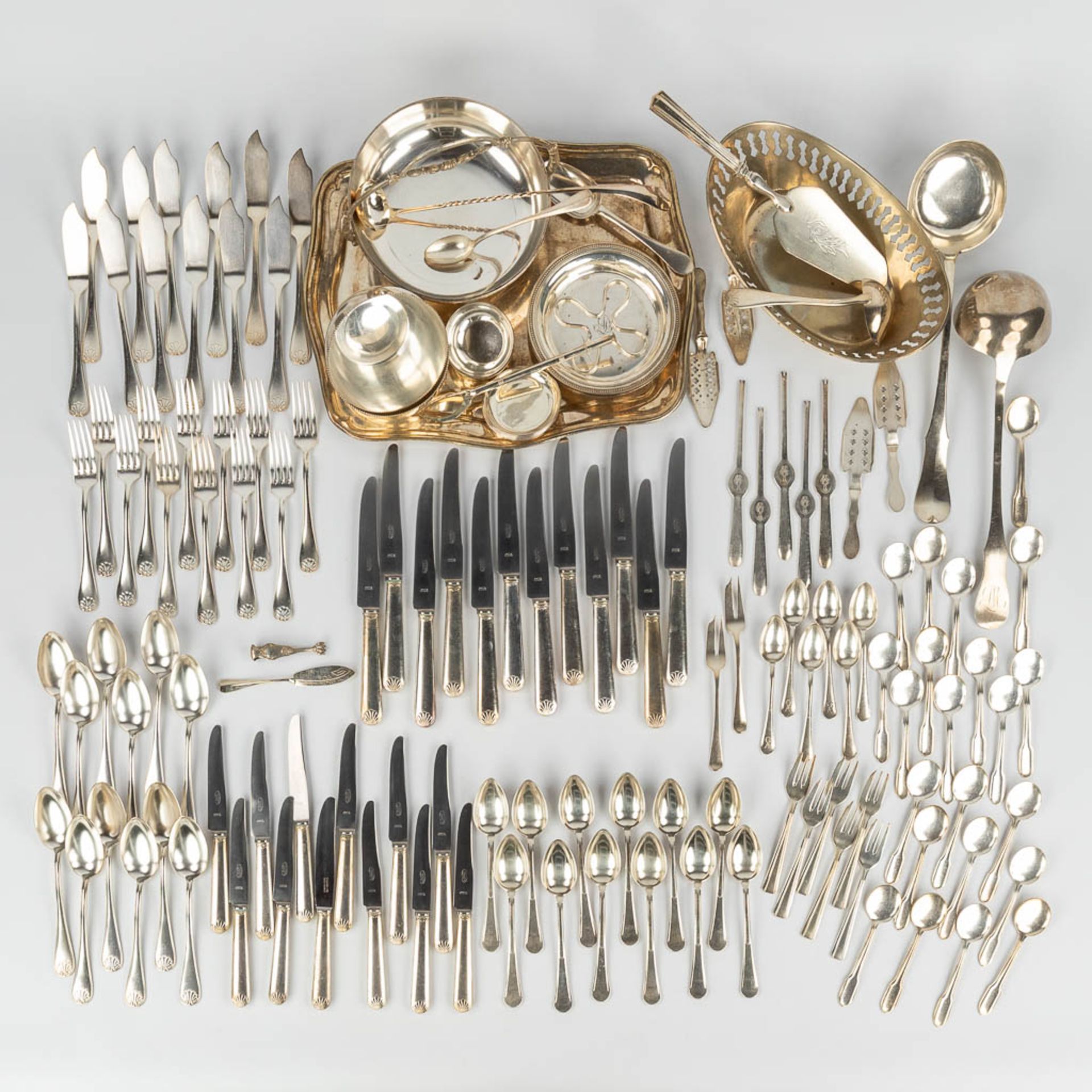 A large collection of cutlery and table accessories made of silver-plated metal.
