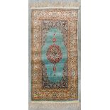 An Oriental hand-made carpet, made of silk.Ê(121 x 61 cm)