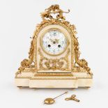 A table clock made of white marble mounted with gold-plated bronze in Louis XVI style. (12 x 32 x 33