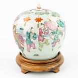 A Chinese pot with lid, 'AÊlady on top of a mythological figurine' made of porcelain (22,5 x 22 cm)