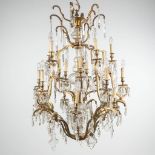 A large chandelier made of bronze and mounted with glass. (110 x 84cm)