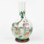A Chinese vase, decorated with a wise man, lady and a deer, two boys with a peach. Marked Qianlong,