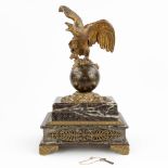 AÊmantle clock made of marble mounted with patinated bronze in empire style and decorated with an ea