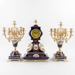 A three-piece porcelain mantle garniture clock and candelabra (19 x 30 x 50cm)