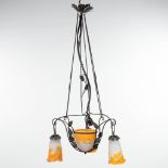 A chandelier in art deco style made of cast-iron and finished with pate-de-verre shades marked Mulle