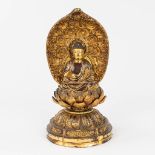 A wood sculptured Buddha, sitting on a lotus flower. (H:28 cm)