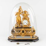 A mantle clock made of gilt spelter, standing under a glass dome. 19th C. (W:40 x H:47 cm)