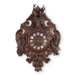 A cartel clock 'Black Forest' made of sculptured wood, with a deer head. (W:45 x H:67 cm)