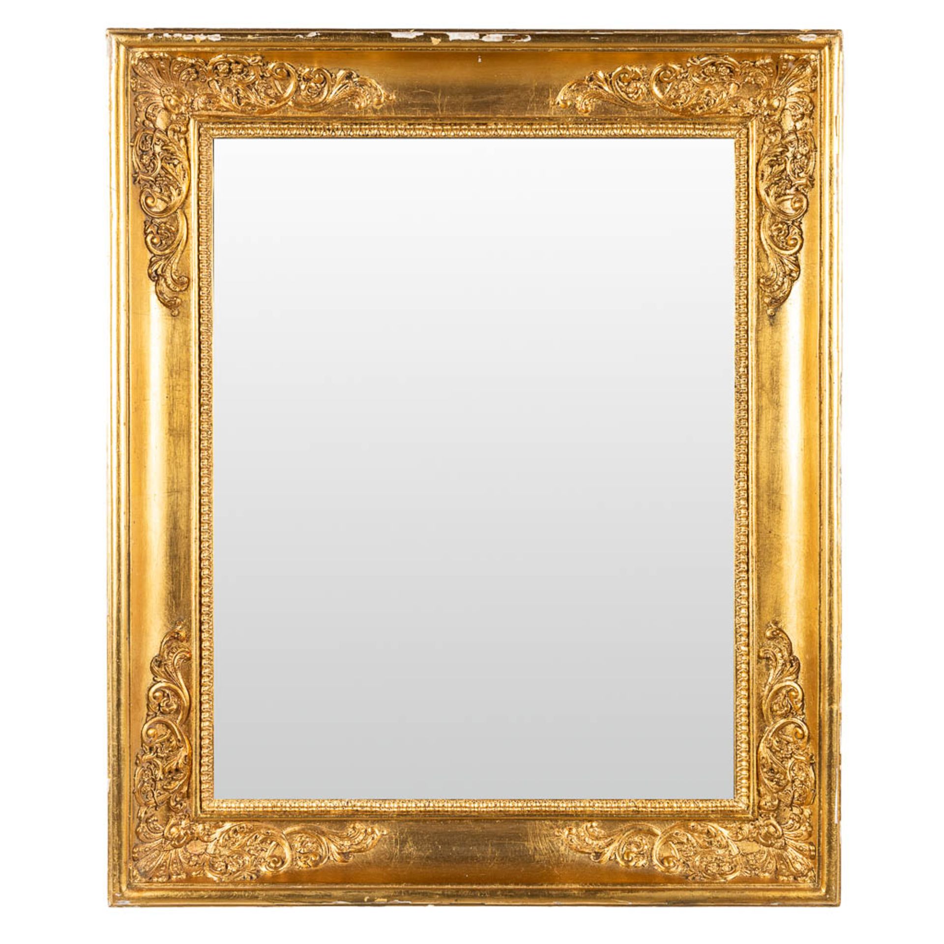 A mirror framed in an empire syle frame. (W:62 x H:74 cm)