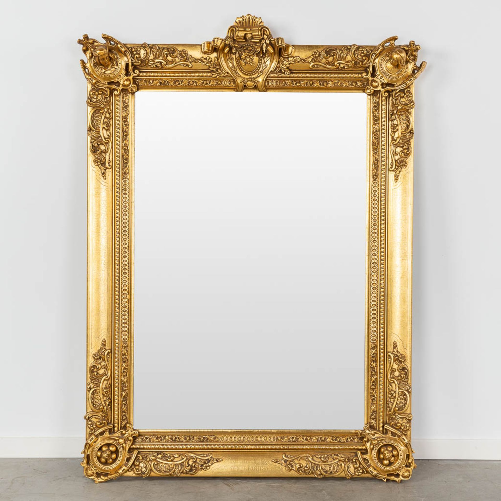 A gold-plated mirror, made of wood an stucco. 20th C. (W:104 x H:145 cm)