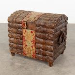 A decorative chest with wood sculptures finished with fabric. (L:39 x W:64 x H:51 cm)