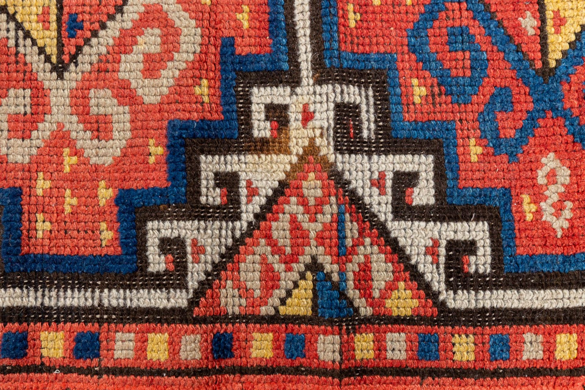 An oriental hand-made carpet. Kazak Caucasian. (L:315 x W:104 cm) - Image 3 of 9