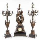 A three-piece garniture clock and candelabra, made of spelter and decorated with female figurines. (