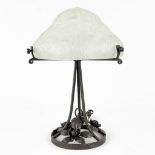 A wrought iron table lamp with opaline glass lamp shade with floral decor. (H:36 x D:25 cm)