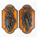 A pair of decorative panels decorated with lobster and fish. Stucco mounted on a wood panel, circa 1