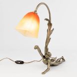 A silver-plated bronze table lamp with reclining lady, and a pate de verre lampshade by Schneider. (