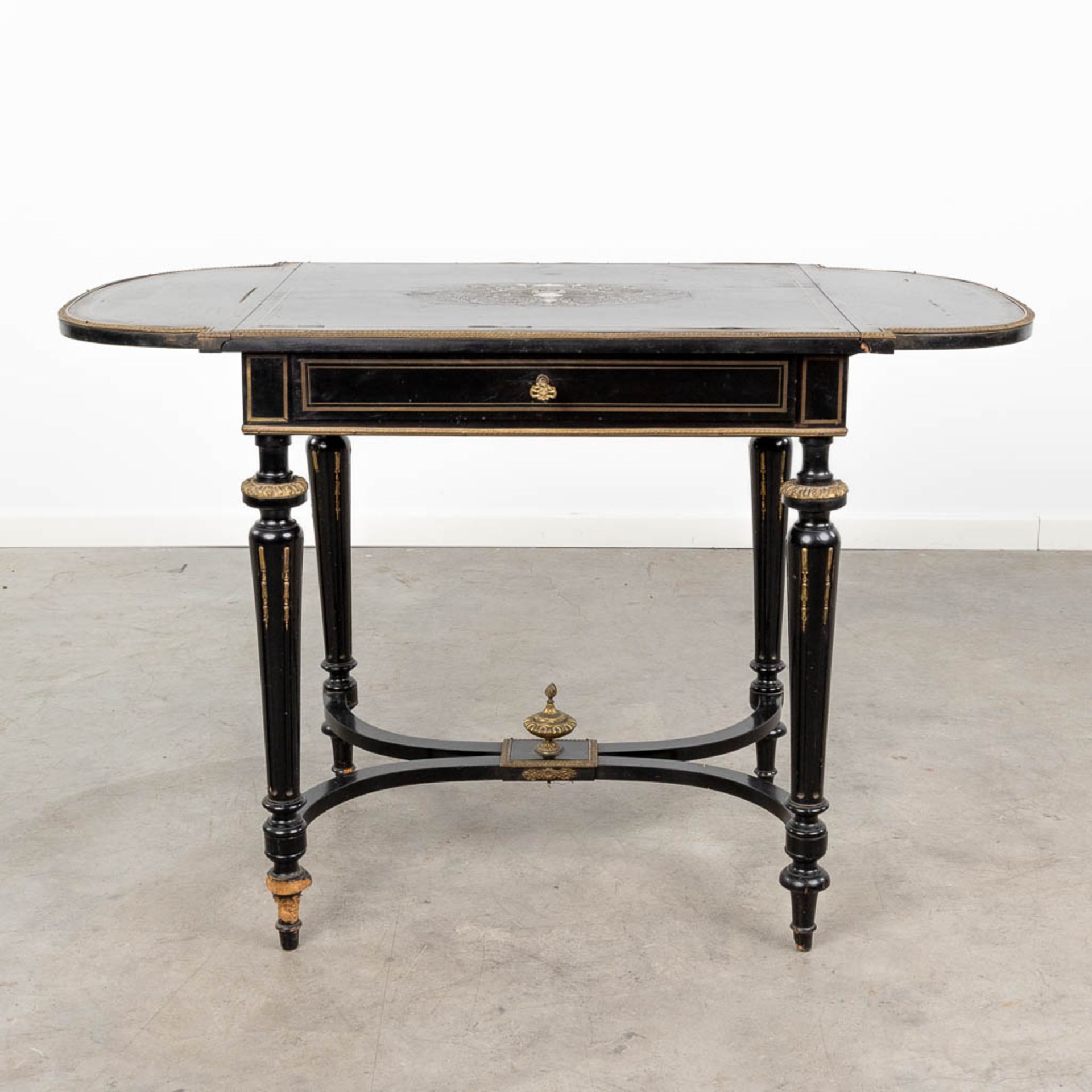 A game table made of ebonised wood inlaid with marquetry and mounted with bronze in Napoleon 3 style