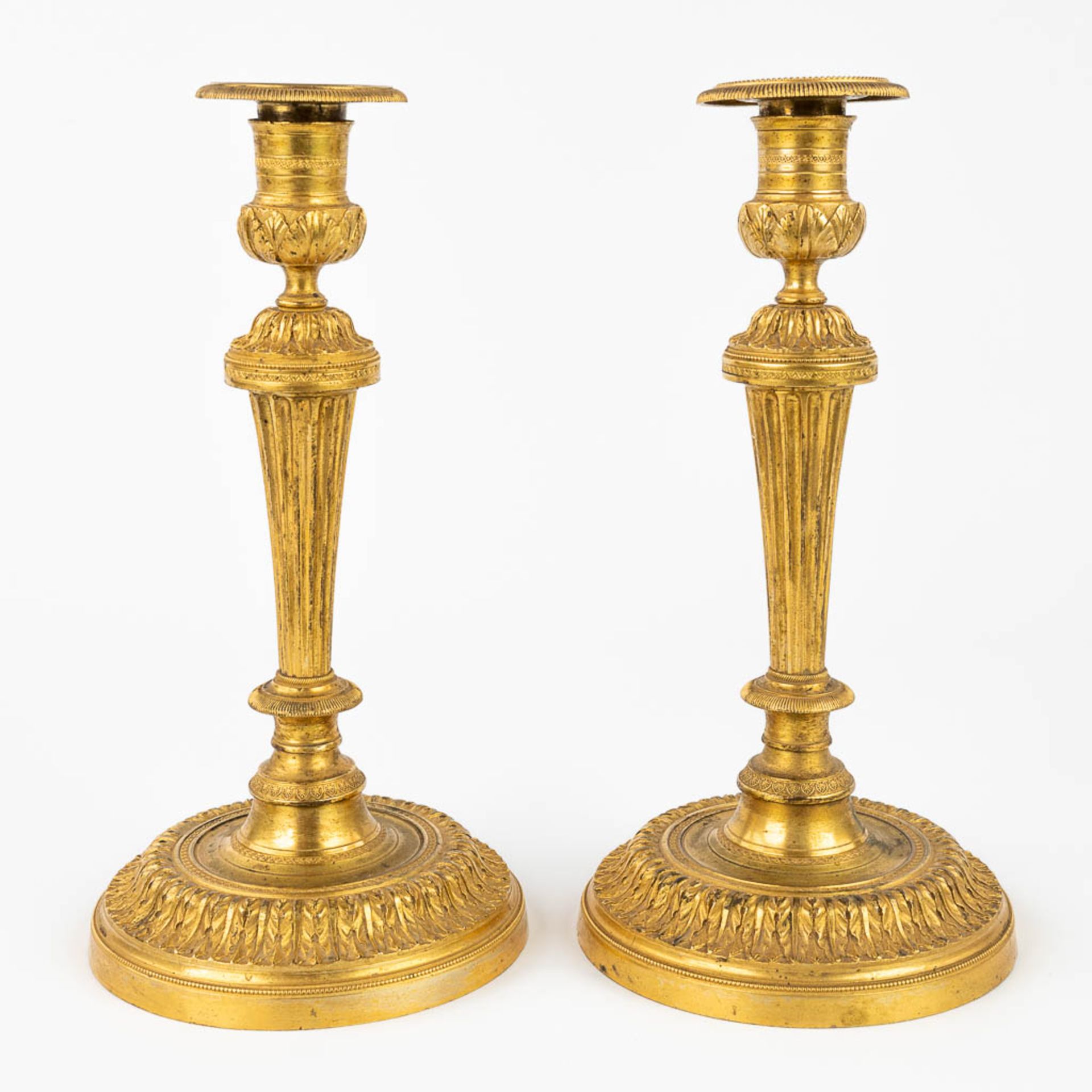 A pair of candlesticks made of gilt bronze in Louis XVI style. 19th C. (H:26 cm)