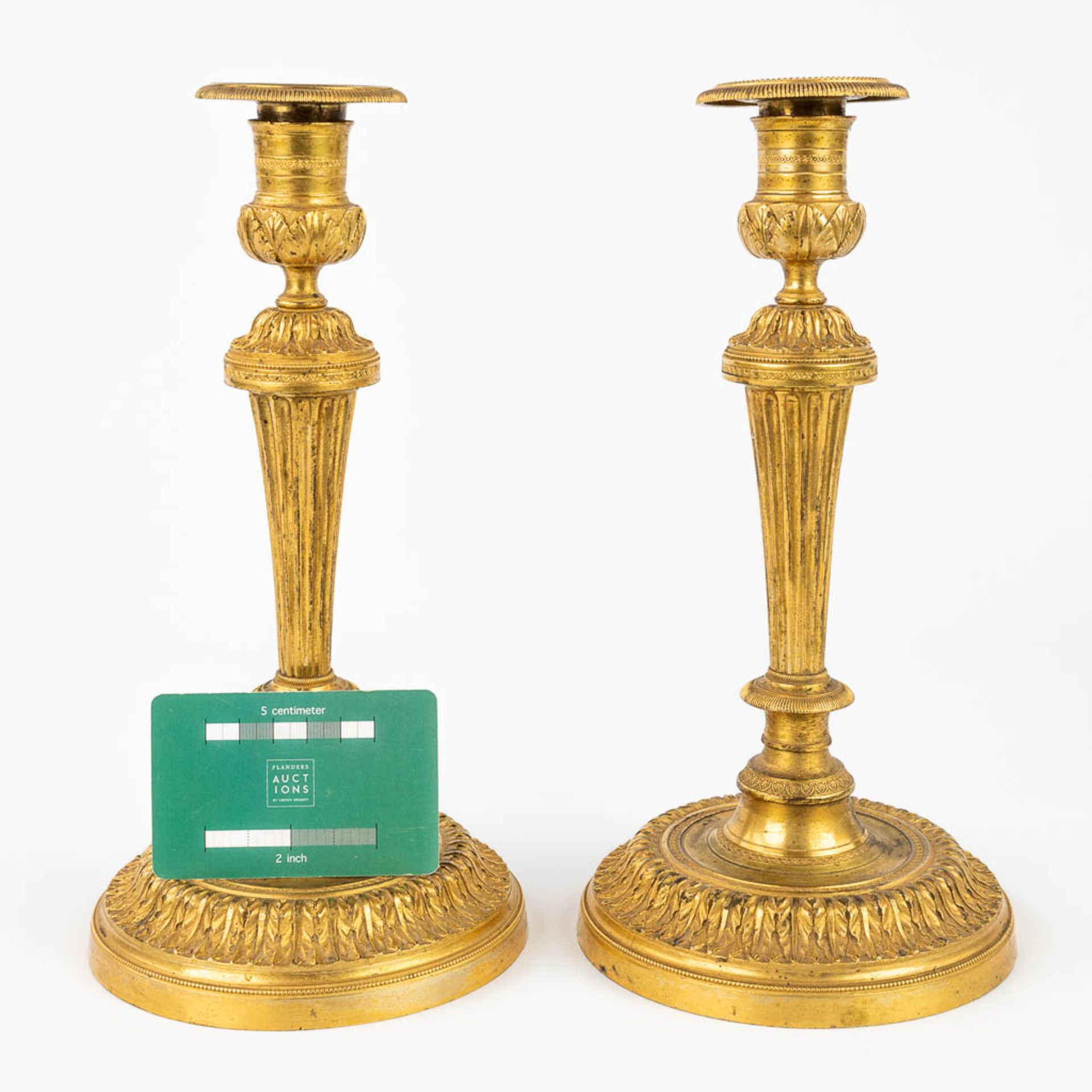 A pair of candlesticks made of gilt bronze in Louis XVI style. 19th C. (H:26 cm) - Bild 2 aus 9