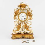 A porcelain table clock with gold-white floral decor. 19th C. (H:33 cm)