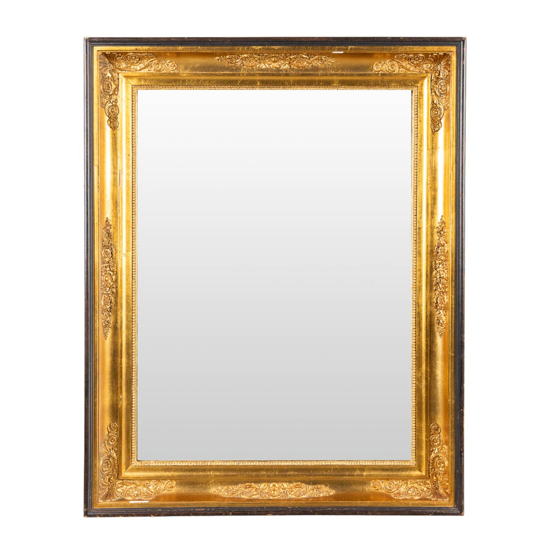 A mirror framed in an empire frame. (W:74 x H:94 cm)