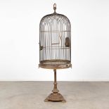 An antique birdcage on a copper stand. Circa 1920. (H:180 x D:58 cm)