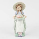 Lladro 'The Girl with Flowers' a statue, glazed porcelain (H:24,5 cm)