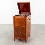 An antique Maestrophone 'His Master's Voice' mounted in a cabinet, with additional bakelite records.