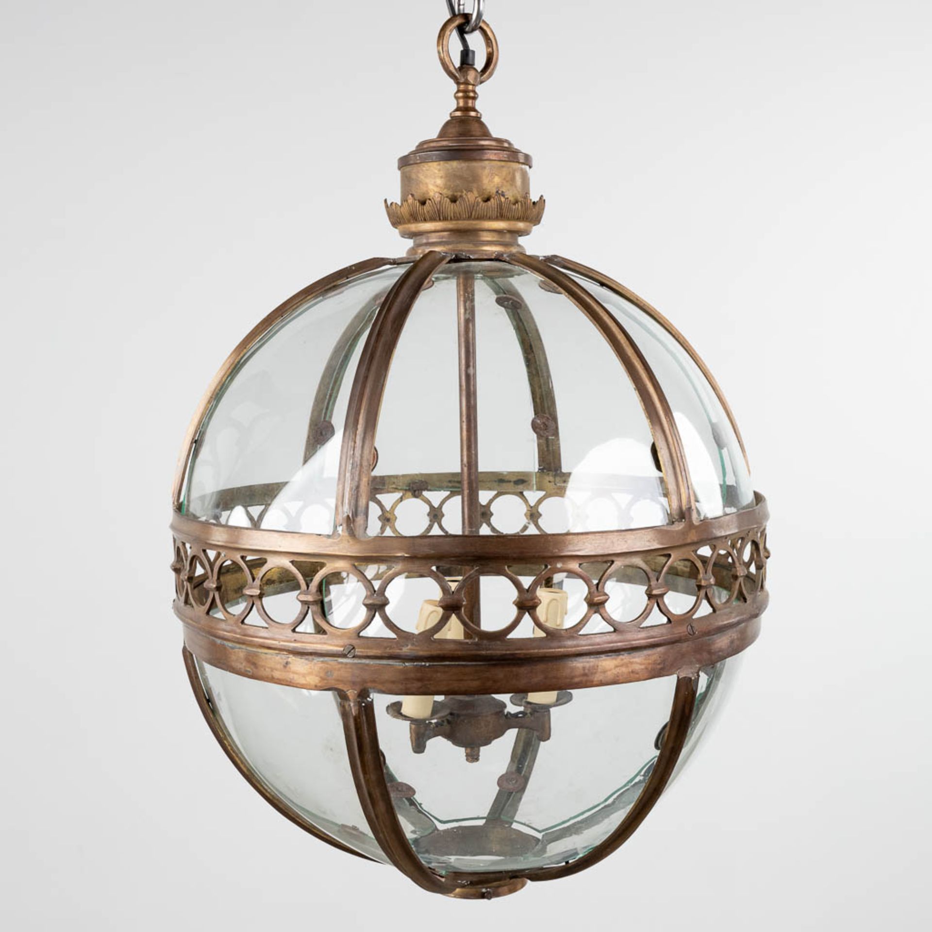 A lantern in the shape of a ball, made of glass and brass. 20th C. (H:70 x D:56 cm)
