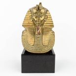 A death mask of Tutankhamun, made of polished bronze (L:18 x W:24 x H:32 cm)