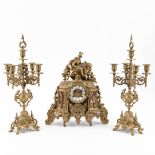 A three-piece mantle garniture clock and candelabra, made of bronze. Circa 1970. (H:42 cm)