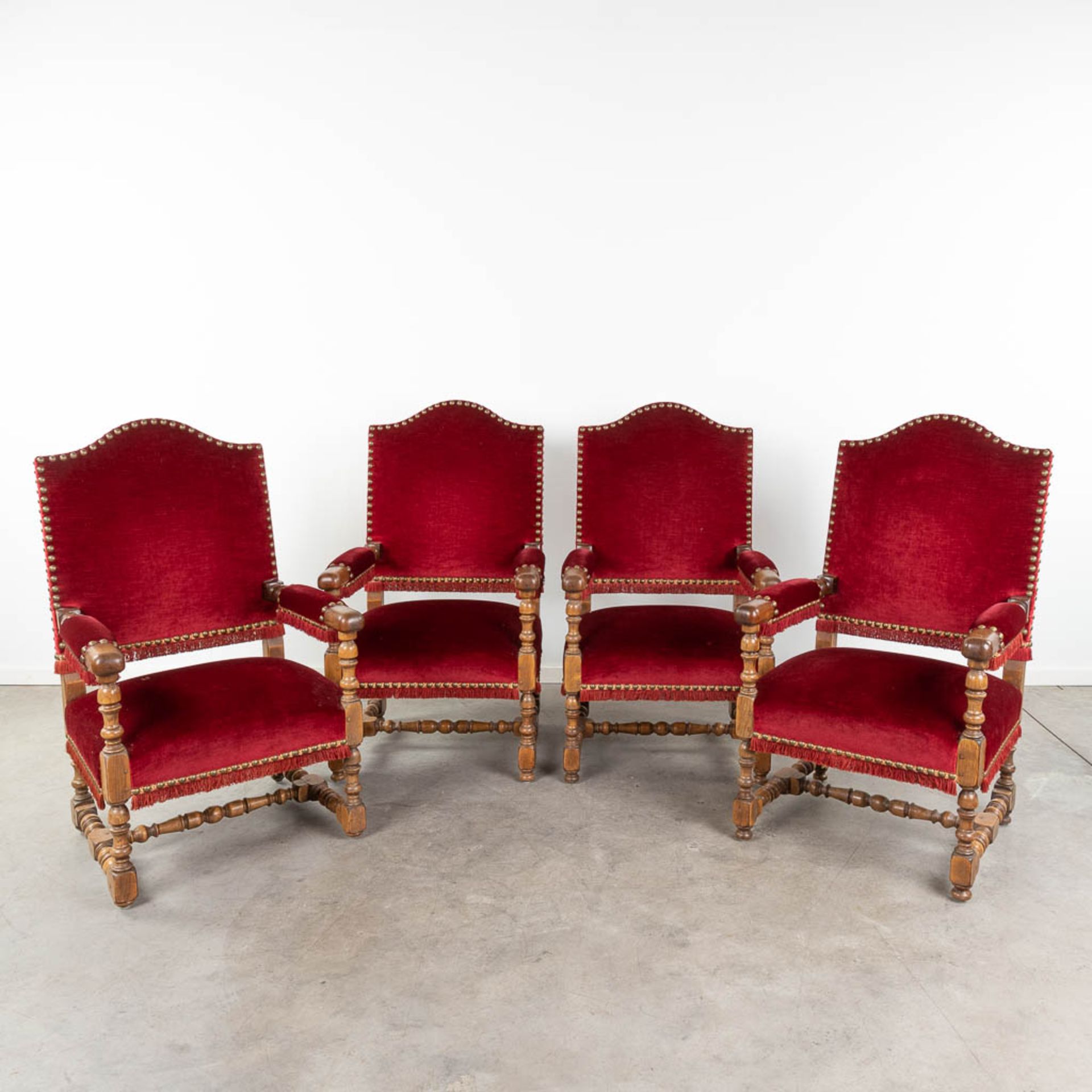A set of 4 armchairs finished with red fabric. (L:70 x W:66 x H:115 cm)