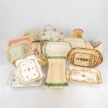A collection of antique asparagus plates, made of glazed ceramics and porcelain. (L:21 x W:48 x H:8
