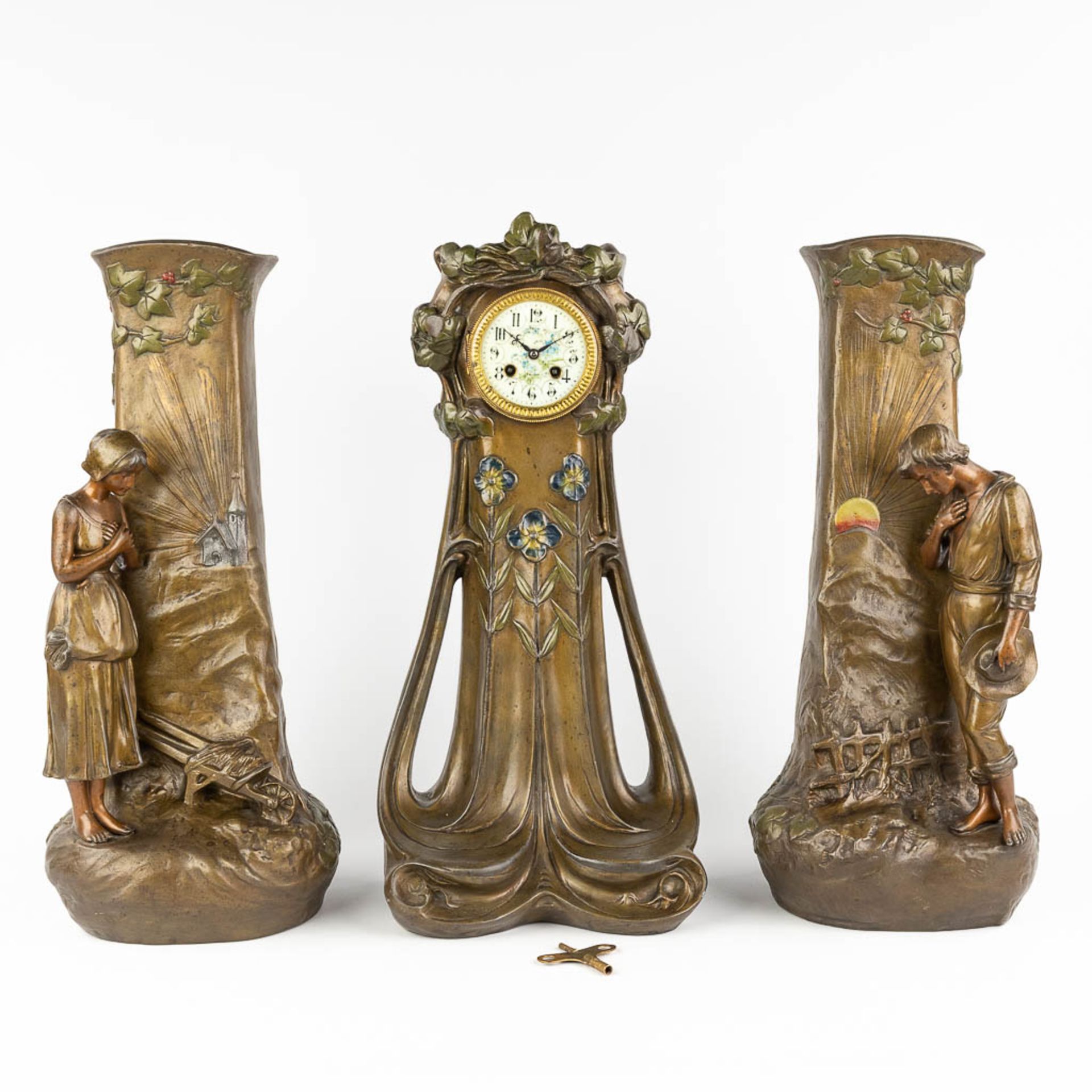 Aristide DE RANIERI (1865-c.1929) A three-piece mantle garniture clock and side pieces, made of spel