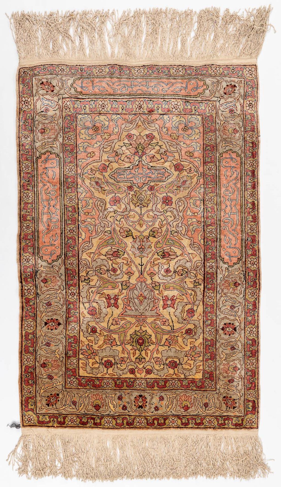 An Oriental hand-made carpet, silk. Hereke. (L: 60 x W: 92 cm)