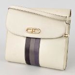 Delvaux, a handbag made of white leather decorated with colored stripes, and gold-plated hardware. (