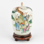 A Chinese porcelain jar with a lid, decorated with wise men and calligraphic texts. 19th/20th C. (H: