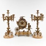 A three-piece mantle garniture clock and candelabra, made of bronze and onyx. 20th C. (L: 18 x W: 36